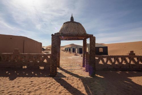 a small structure in the middle of the desert at Erg Chegaga Desert Standard Camp in Mhamid