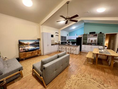 a living room with a couch and a table at Tranquil holiday home on the water’s edge. in Rainbow Beach