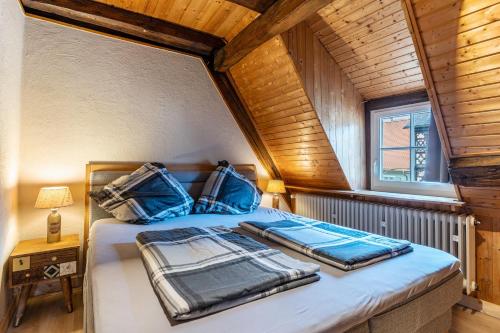 a bedroom with a bed with blue pillows on it at Gästehaus Siebter Himmel in Burkheim