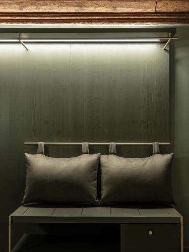 a pillow sitting on a bench under a light at Altstadthotel Weisses Kreuz in Innsbruck