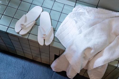 a bathroom with two white towels on the wall at Hotel des Carmes by Malone in Paris