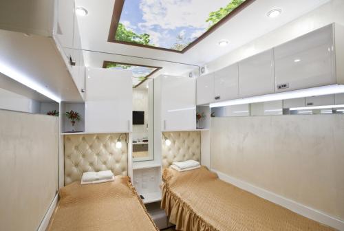 a room with two beds and a skylight at Гостиница Arderia in Ufa