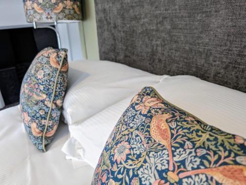 a bed with two pillows on top of it at The White Hart Inn, Hawes in Hawes