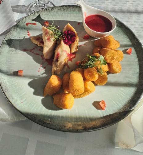 a plate with some food on a table at Kemence Csárda és Szálloda in Nyíregyháza
