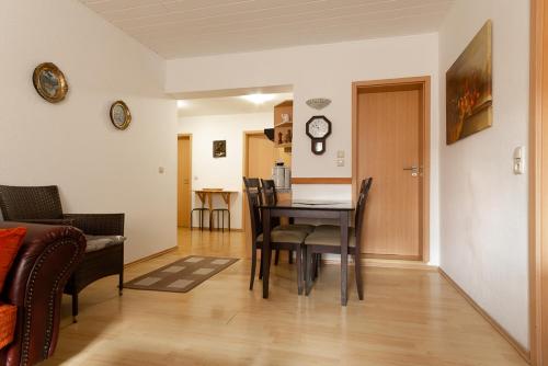 a dining room and living room with a table and chairs at Feriendorf Slawitsch in Bad Sulza