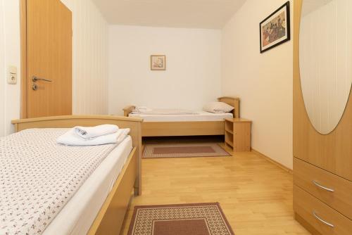 a bedroom with two beds and a mirror at Feriendorf Slawitsch in Bad Sulza