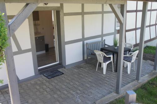 a patio with a table and chairs on it at Feriendorf Slawitsch in Bad Sulza
