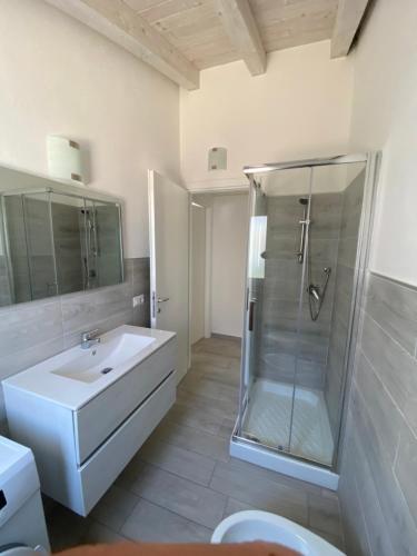 a bathroom with a shower and a sink and a toilet at Villetta 2 La Caletta in La Caletta