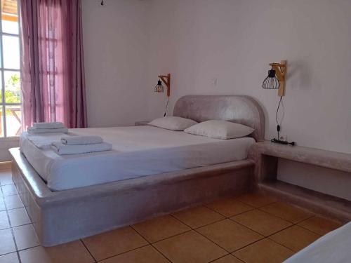 a bedroom with a large bed in a room at SOHOROS STUDIOS in Irakleia