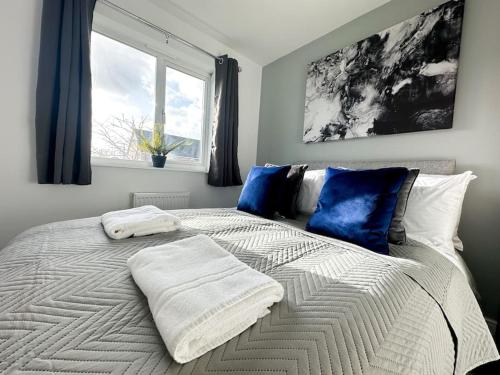 a bedroom with a bed with two towels on it at No.32 by Blue Skies Stays in Bowburn
