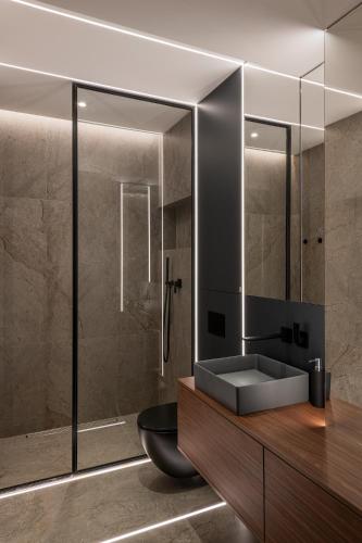 a bathroom with a sink and a shower at Boudoir Apartment City Tower - 15th floor in Cluj-Napoca