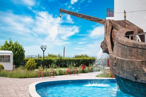 a swimming pool with a pirate ship water slide at Privilege Fort Beach Apartments in Sveti Vlas