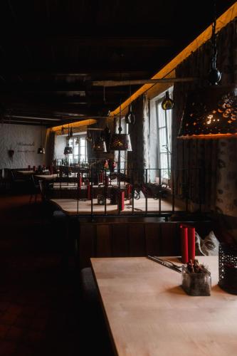 a dark room with a table and some chairs at Landhotel und Weingasthof Schwarzer Adler in Wiesenbronn