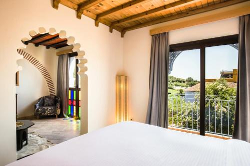 a bedroom with a bed and a large window at Dar Echchaouen Maison d'Hôtes & Riad in Chefchaouen