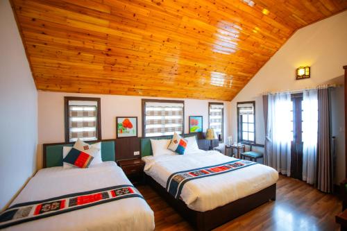 Giường trong phòng chung tại Le Boutique Sapa Hotel