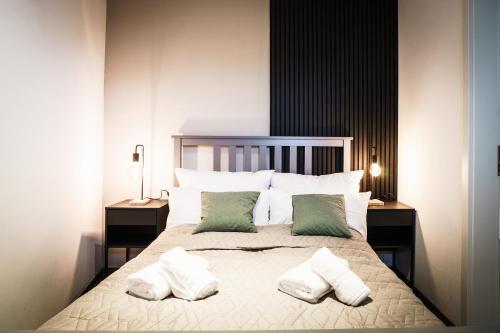a bedroom with a large bed with two pillows at O24 Neu I Zentral I Parkplatz I Fahrstuhl I Design I King I Küche in Ibbenbüren