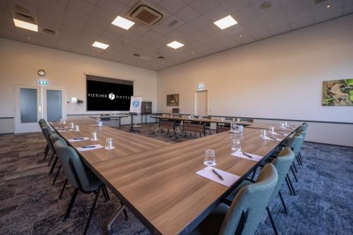 a large conference room with a large table and chairs at Fletcher Hotel - Restaurant de Zeegser Duinen in Zeegse
