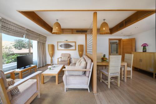 a living room with a couch and a table at Mövenpick Resort Aswan in Aswan
