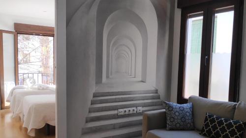 a room with a staircase leading to a bedroom at Rabat Al- Bayyatin , Plaza larga in Granada