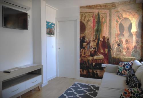 a living room with a painting on the wall at Rabat Al- Bayyatin , Plaza larga in Granada
