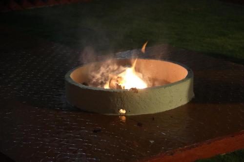 a fire in a pot on a table at HAILSTONE HOME STAY in Ooty