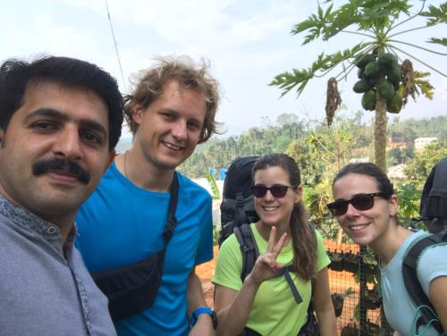 a group of three people posing for a picture at Western Ghats Holiday Home in Kalpetta