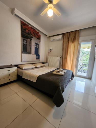 a bedroom with a bed and a ceiling fan at 4ALL Airport 10min,Sea100m,Free parking in Thessaloniki