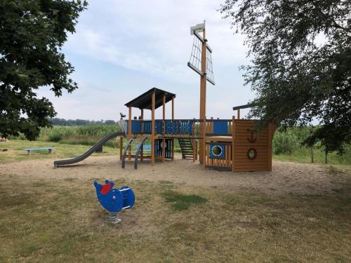 a playground in a park with a play equipment at NEU! Bungalow am Kummerower See TOP in Verchen