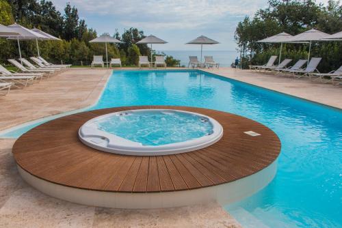 a swimming pool with a hot tub on a wooden deck at Villa Lattanzi in Marina Palmense