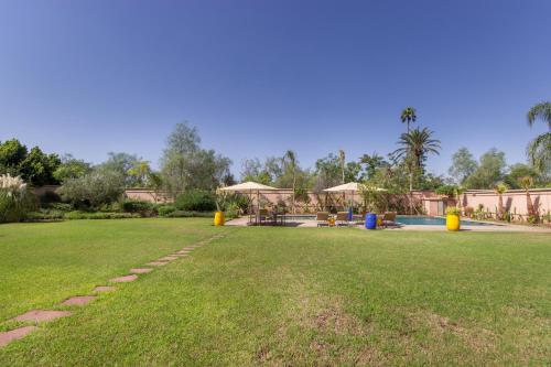 a large yard with a pool and a park at Luxury Villa GoldPalm Marrakech in Marrakech