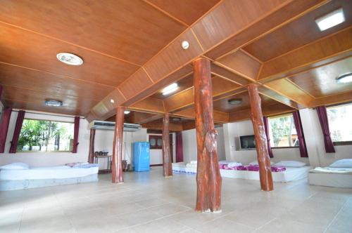 a room with two beds and a wooden ceiling at Techno Riverview Resort in Kamphaeng Phet