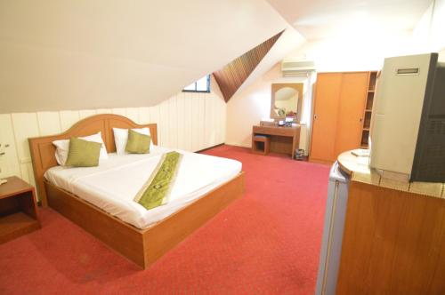 A bed or beds in a room at Techno Riverview Resort