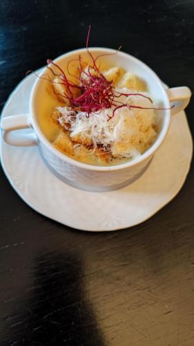 a bowl of soup on a plate on a table at Dwór na Wolicy in Dębica