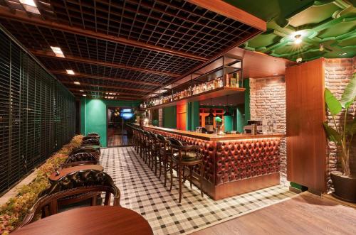 a restaurant with a bar with tables and chairs at Azuu Boutique Hotel in Antalya