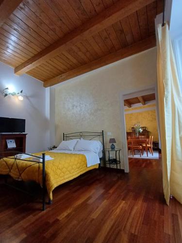 a bedroom with a bed and a dining room at Aquila Antica in LʼAquila