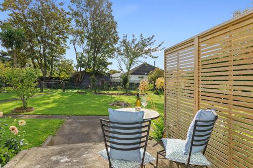 a patio with a table and chairs and a fence at Peaceful Country Retreat in Moutoa