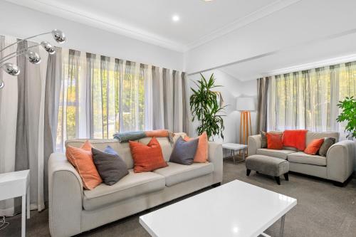 a living room with two couches and a large window at Peaceful Country Retreat in Moutoa
