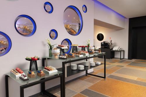 a room with a bunch of tables with desserts at Sofitel Warsaw Victoria in Warsaw