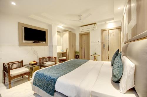 a bedroom with a large bed and a television at Hotel International Inn - Near Delhi Airport in New Delhi