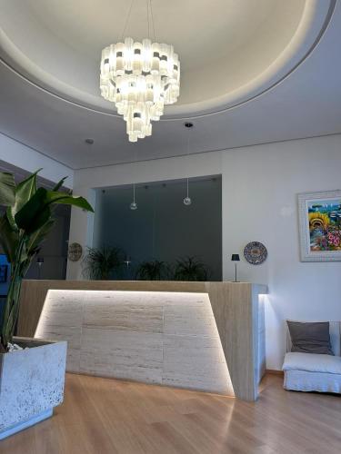 a living room with a table and a chandelier at Saint Joseph in Salerno