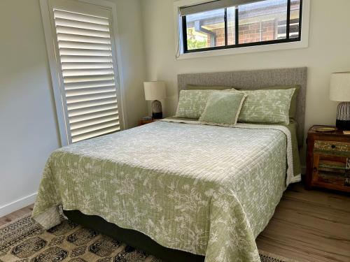 a bedroom with a bed and a window at Lola’s@lennox in Lennox Head