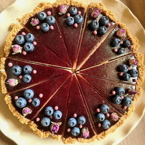 a chocolate dessert with blueberries andrants on a plate at Penzion Diana in Kunžak