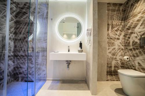 a bathroom with a sink and a mirror at Catania Sea Palace Hotel in Catania