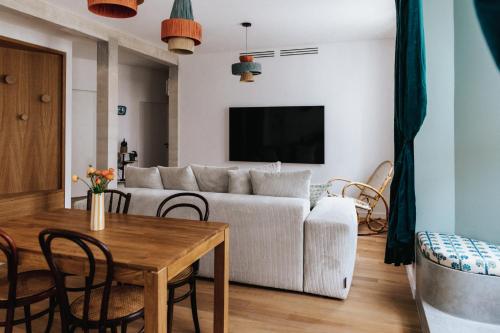 a living room with a couch and a table at Maison Hubert in Bordeaux