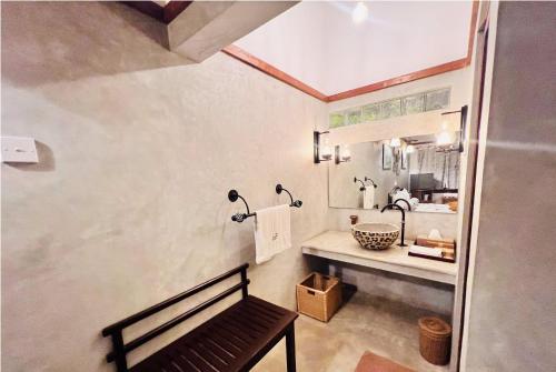a bathroom with a sink and a bench in a room at Yala Leopard Lodge in Yala