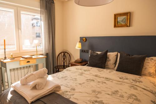 a bedroom with a bed with a towel on it at Casa Wenceslao in Pola de Laviana