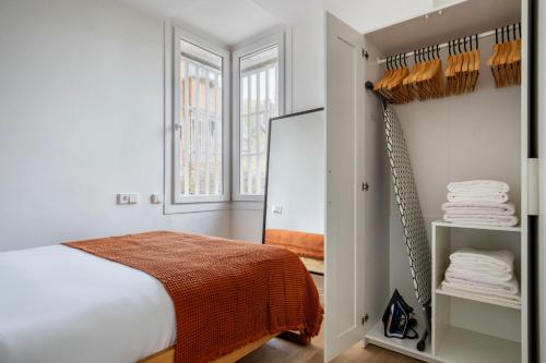 a bedroom with a bed and a closet at Blueground Sarrià doorman newly renovated BCN-119 in Barcelona