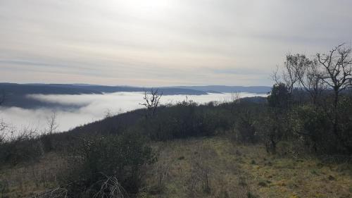 a view of a valley of clouds in the sky at Seuls en Pleine Nature - Gîte la Côte Blanche in Puygaillard-de-Quercy