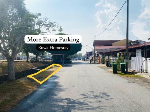 a street with a sign that says more extra parking at Ruwa Homestay in Jitra