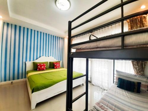 a bedroom with two bunk beds with green sheets at Rocky Party Pool Villa Huahin 3 Bedrooom With BBQ & Karaoke in Hua Hin